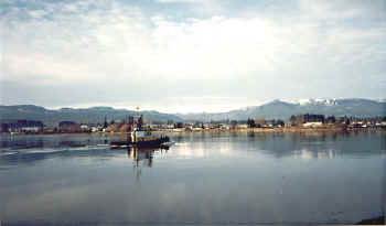 Tug boats ply the river at high tide.